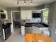 Well-lit kitchen boasting stainless steel appliances, tile backsplash and eat in dining area at 11720 Grenadier Ln, Indianapolis, IN 46229