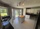 Bright kitchen featuring white cabinetry, a center island, and views of the outdoors at 11720 Grenadier Ln, Indianapolis, IN 46229