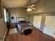 Spacious main bedroom featuring hardwood floors, a ceiling fan, and ample closet space at 11720 Grenadier Ln, Indianapolis, IN 46229