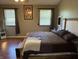 Relaxing main bedroom featuring a large bed, natural light, and comfortable furnishings at 11720 Grenadier Ln, Indianapolis, IN 46229