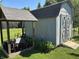 This shed is used for storage and features a covered area for storing wood. A wheelbarrow is also visible at 11720 Grenadier Ln, Indianapolis, IN 46229