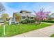 Charming home with well-maintained lawn, white picket fence, and blooming tree at 1641 Winton Ave, Indianapolis, IN 46224