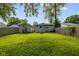 Spacious backyard featuring a lush lawn, wooden fence, detached garage, and inviting fire pit at 3125 N Tacoma Ave, Indianapolis, IN 46218