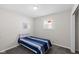Cozy bedroom with a blue striped bed, neutral walls, and a window offering natural light at 3125 N Tacoma Ave, Indianapolis, IN 46218