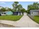 Charming single-story home with a long driveway, well-maintained lawn, and convenient detached garage at 3125 N Tacoma Ave, Indianapolis, IN 46218