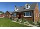 Well-maintained brick house with a bright red front door and a neatly landscaped front yard at 3192 E Main St, Plainfield, IN 46168