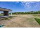 Expansive backyard with covered patio and an outdoor fireplace at 6596 Dogwood Dr, McCordsville, IN 46055