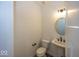 Half bathroom featuring white fixtures, pedestal sink, modern lighting and dark accents at 6596 Dogwood Dr, McCordsville, IN 46055