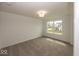 Bedroom featuring neutral carpet, ample natural light from a large window overlooking the front yard at 6596 Dogwood Dr, McCordsville, IN 46055