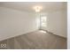 Carpeted bedroom with a ceiling light and a single window that looks out to the backyard at 6596 Dogwood Dr, McCordsville, IN 46055