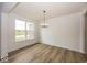 Inviting dining room with a modern chandelier, hardwood floors, and natural light at 6596 Dogwood Dr, McCordsville, IN 46055