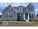 Charming two-story home with gray brick, white trim and a welcoming front porch at 6596 Dogwood Dr, McCordsville, IN 46055