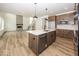 Open-concept kitchen with island, modern appliances, and hardwood floors adjacent to living area at 6596 Dogwood Dr, McCordsville, IN 46055