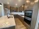 Modern kitchen features quartz countertops, stainless steel appliances, and ample cabinet space at 6596 Dogwood Dr, McCordsville, IN 46055