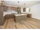 Modern kitchen with a large island, quartz countertops, and stylish pendant lighting at 6596 Dogwood Dr, McCordsville, IN 46055