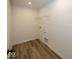 Compact laundry room with wood-look flooring and connections for washer and dryer at 6596 Dogwood Dr, McCordsville, IN 46055