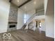 Spacious living room with fireplace and staircase at 6596 Dogwood Dr, McCordsville, IN 46055