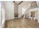 Stunning living room with a stone fireplace, high ceilings, and lots of natural light at 6596 Dogwood Dr, McCordsville, IN 46055