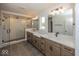 Main bathroom featuring double vanity, modern fixtures, and a glass enclosed walk-in shower at 6596 Dogwood Dr, McCordsville, IN 46055