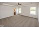 Spacious main bedroom with neutral carpet, tray ceiling, and large windows for ample natural light at 6596 Dogwood Dr, McCordsville, IN 46055