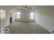Spacious main bedroom featuring neutral carpet, a ceiling fan, and plenty of natural light from two windows at 6596 Dogwood Dr, McCordsville, IN 46055