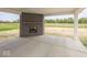 Covered patio with brick fireplace and concrete flooring at 6596 Dogwood Dr, McCordsville, IN 46055