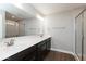 A bright bathroom with a double sink vanity, large mirror, and a glass-enclosed shower at 7340 W County Road 600 Rd, McCordsville, IN 46055