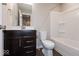 A full bathroom with a toilet, dark cabinets, white marble counters, and a tub and shower combo at 7340 W County Road 600 Rd, McCordsville, IN 46055