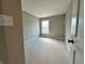 A view of a quiet, grey bedroom with natural light from a single window at 7340 W County Road 600 Rd, McCordsville, IN 46055