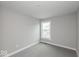 A small carpeted bedroom featuring neutral walls and a window that overlooks the neighborhood at 7340 W County Road 600 Rd, McCordsville, IN 46055