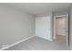 A cozy bedroom is painted light gray with a closet and white doors with carpet at 7340 W County Road 600 Rd, McCordsville, IN 46055