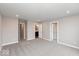 An open, carpeted bedroom showcasing multiple doorways and windows, offering ample space and natural light at 7340 W County Road 600 Rd, McCordsville, IN 46055