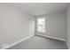 A simple bedroom with neutral carpet, recessed lighting, and a window with a view at 7340 W County Road 600 Rd, McCordsville, IN 46055