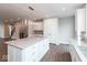 Modern open concept kitchen with large island, white cabinets, and wood floors adjoins living area at 7340 W County Road 600 Rd, McCordsville, IN 46055