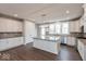 Bright kitchen featuring white cabinets, stainless steel appliances, a large island, and wood-look flooring at 7340 W County Road 600 Rd, McCordsville, IN 46055