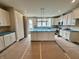 Bright, unfinished kitchen featuring white cabinets, center island, and stainless steel appliances at 7340 W County Road 600 Rd, McCordsville, IN 46055