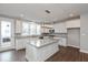 Bright kitchen featuring white cabinets, stainless steel appliances, a large island, and wood-look flooring at 7340 W County Road 600 Rd, McCordsville, IN 46055