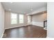 Open living room with two windows, wood-style flooring, and white trim along the base of the wall at 7340 W County Road 600 Rd, McCordsville, IN 46055