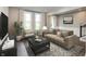 Relaxing living room with comfortable seating, a decorative rug, and natural light from the windows at 7340 W County Road 600 Rd, McCordsville, IN 46055