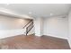 Open living room with dark wood style floors, white wall trim and a staircase in the back at 7340 W County Road 600 Rd, McCordsville, IN 46055