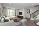 Cozy living room featuring a comfortable sectional sofa, modern decor and large window for natural light at 7340 W County Road 600 Rd, McCordsville, IN 46055