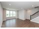 Spacious living room with wood floors, staircase and light gray walls at 7340 W County Road 600 Rd, McCordsville, IN 46055