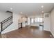 Spacious living room with wood floors, staircase and light gray walls at 7340 W County Road 600 Rd, McCordsville, IN 46055