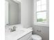 A well-lit powder room featuring a vanity with white countertop and a window for natural light at 7340 W County Road 600 Rd, McCordsville, IN 46055