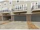 Rear exterior featuring private balconies and garages of newly constructed townhouses, ensuring modern living at 7340 W County Road 600 Rd, McCordsville, IN 46055