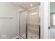 A modern shower with glass enclosure, tiled walls, and a built-in bench seat at 7340 W County Road 600 Rd, McCordsville, IN 46055