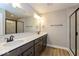 Modern bathroom featuring double sinks, quartz countertops, and a glass-enclosed shower at 7344 W County Road 600, McCordsville, IN 46055