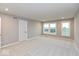 Bedroom with neutral carpet, light gray walls, and large windows offering abundant natural light at 7344 W County Road 600, McCordsville, IN 46055