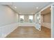 Versatile bonus room with white wainscoting, wood floors and glass paneled double doors at 7344 W County Road 600, McCordsville, IN 46055