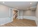 Finished basement with wainscotting, wood floors, recessed lighting, and glass paneled double doors at 7344 W County Road 600, McCordsville, IN 46055